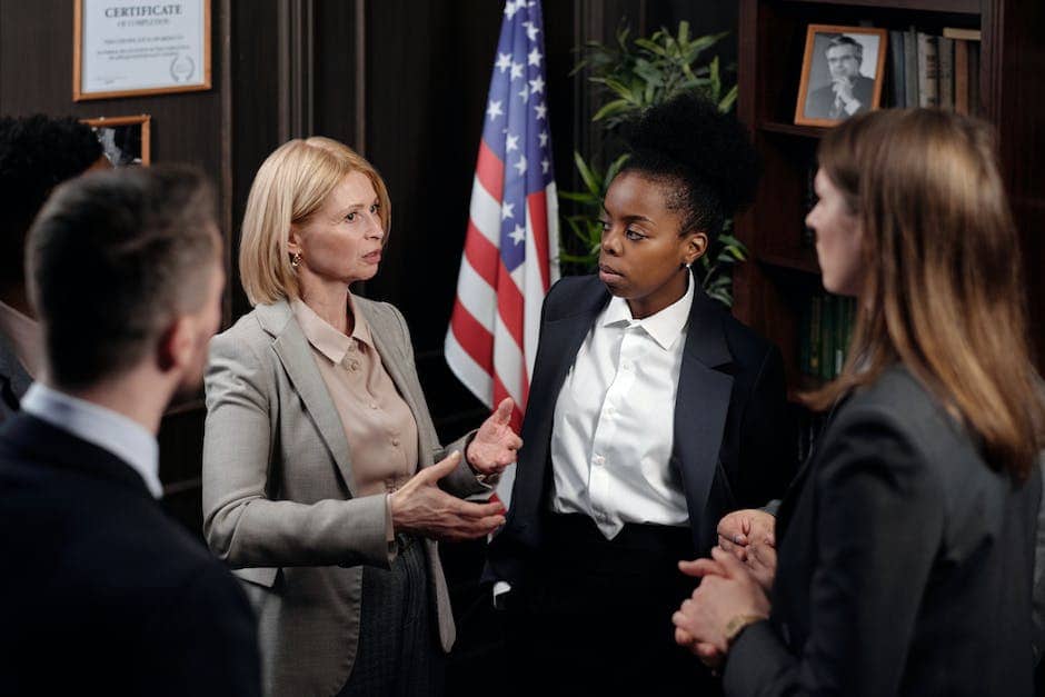 A group of people sitting around a table and discussing legal matters